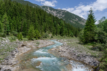 Fototapeta na wymiar Wonderful small river flowing in the Alps