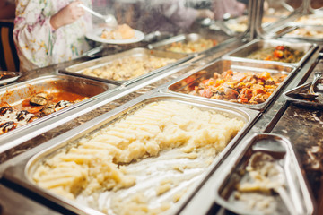 Assortment of fresh dishes displayed in hotel buffet. Variety of food in canteen ready for dinner