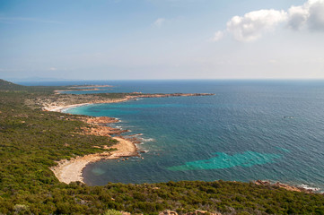 View of the wooded coast and sandy beaches with the clear blue sea on the island of Corsica