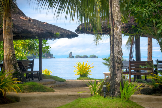 Island Beach Huts and Exotic Rock Formations at Sea