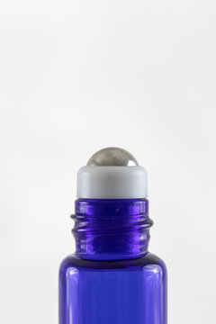 Blue glass roller ball bottle with metal roller ball for essential oils,  massage oils or beauty or wellness serums. 