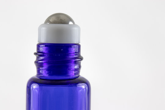Blue glass roller ball bottle with metal roller ball for essential oils,  massage oils or beauty or wellness serums. 