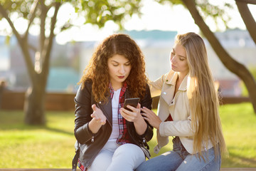 Young woman support and soothe her upsed friend. Two girl during the conversation.