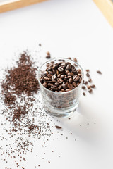 Coffee beans in a glass on a white background 