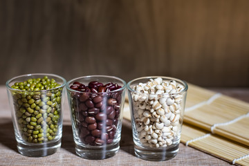 Cereals in glass cups placed on a wooden background