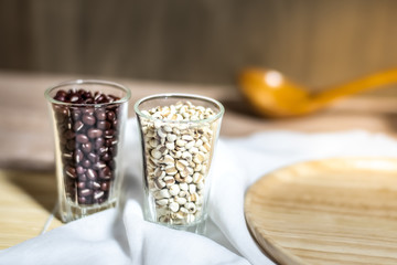 Cereals in glass cups placed on a wooden background