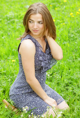 Naklejka na ściany i meble young woman in dress relaxing in garden 