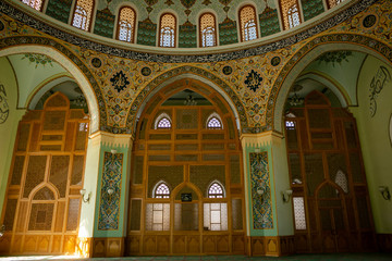 Istanbul mosque-view from the inside. Hand-painted walls, hand-carved wooden walls and Windows,hand-painted window panes,wall lamps and chandeliers.