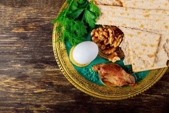 Pesah concept jewish Passover holiday. Traditional pesah seder plate with celery, egg, bone, maror, charoset Passover Haggadah
