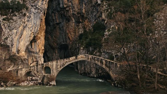 Aerial, bridge over flowing water in Pindus