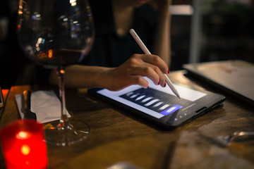 girl designer illustrator working on new pro tablet with stylus at cafe