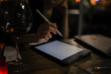 girl designer illustrator working on new pro tablet with stylus at cafe