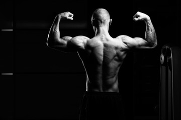 Obraz na płótnie Canvas Bodybuilder Performing Rear Double Biceps Pose