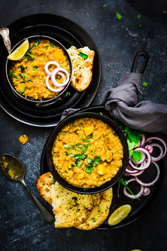 Close up of dal with naan bread served on plate