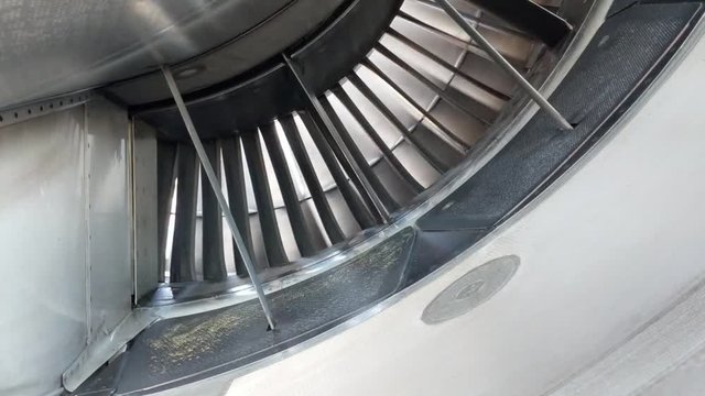 Widebody aircraft engine slowly turning in the wind from the read of the engine.