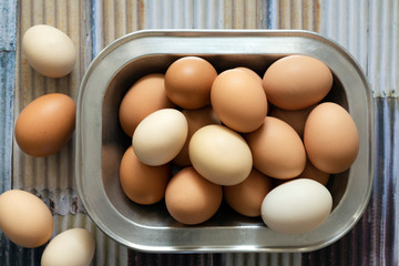 A collection of brown and white eggs.