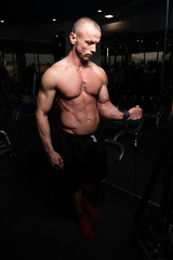 Fototapeta na wymiar Bodybuilder Doing Heavy Weight Exercise For Triceps