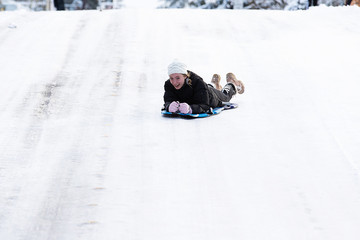 teenage girl on a snow sled