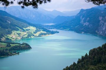 Fototapeta na wymiar Mondsee lake, Austria - aerial view from Drachenwand ridge showing turquoise waters with mountains in the background. Summer holiday destination in Austria. Copy space.