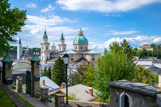 Salzburg, Austria - 14 August 2018: Church towers rising above the houses in Salzburg, as seen from the entry in Stieglkeller Gastgarten, on a bright Summer day