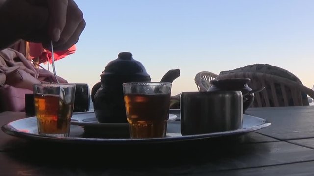 Stirring sweet mint tea in Dahab, Egypt