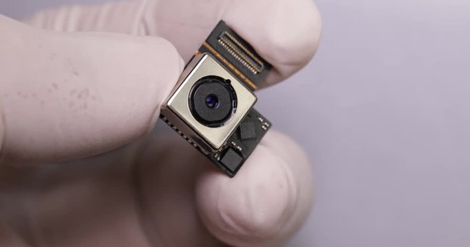 Hand holding digital camera lens part