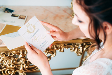 Elegant brunette in silk peignoir sitting at the dressing table