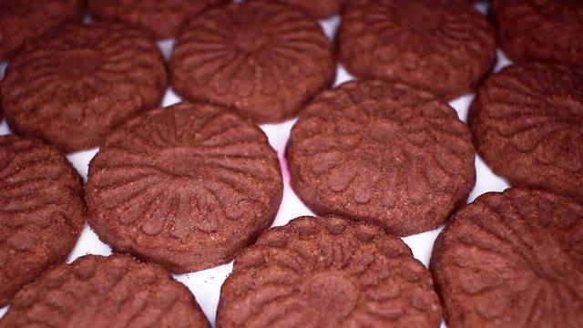 Chocolate biscuit brown chocolate biscuits cacao food closeup texture pattern. Seamless looping video footage
