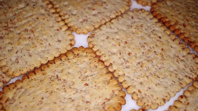 Whole grain healthy cracker biscuit food food closeup texture pattern. Seamless looping video footage