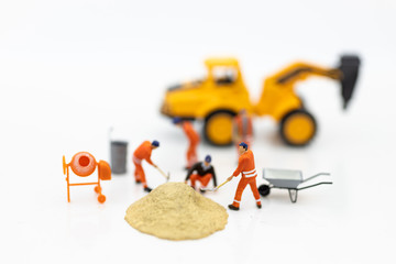 Miniature people: Construction workers building plans , have building materials, sand, brick,...