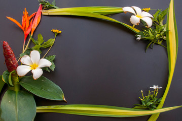 Various flowers arranged on a black table
