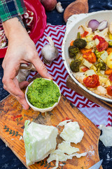 Green dip spread sauce with celery, fresh coriander, dill, parsley, avocado, garlic, olive oil and nuts or seeds. Traditional Italian pesto. Vegetarian vegan healthy food.