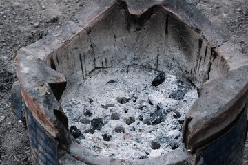Cinders from  burning charcoal and firewood grill in Thai tradition Clay stove.