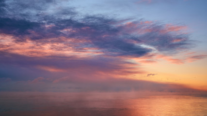 Fototapeta na wymiar Beautiful dreamy sunrise clouds over horizon