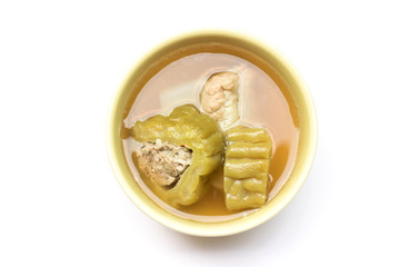 Bitter gourd soup with pork ribs in bowl isolated on white background
