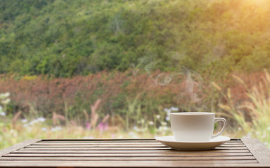 Coffee espresso on wood table nature background in garden,warm tone
