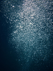 scooba diver bubbles upcoming from a deep sea