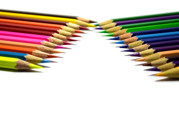 Multiple colored pencils on a white background.