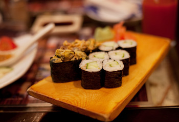 served maki rolls on wooden plate 