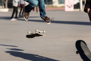 Fototapeta premium Person riding a skate board in an urban asphalt park