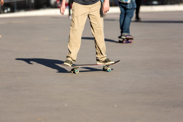 Person riding a skate board in an urban asphalt park