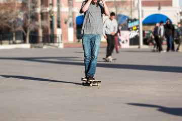 Person riding a skate board in an urban asphalt park
