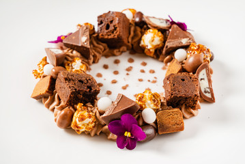 creative dessert with brownie and edible flowers