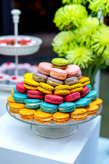 Table with sweets, buffet with colorful macarons, candies.