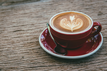 top view of hot coffee latte on wood table background.