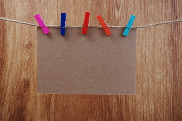empty space copy paper hang with wooden clip and rope on wooden boards background