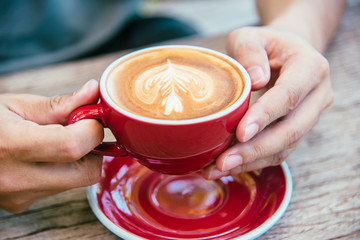 Man holding a cup of coffee at cafe During a break the day.