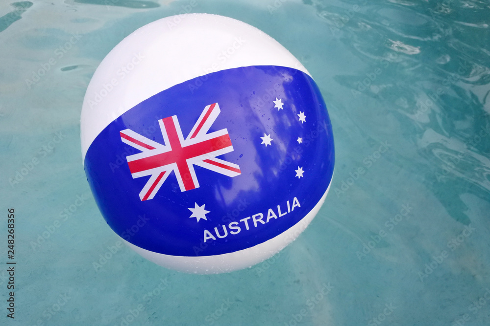 Wall mural australian flag on a ball in a swimming pool