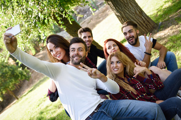 Group of friends taking selfie in urban background