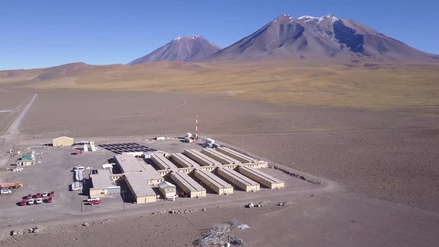 Aerial Footage. Geothermal camp at more than 3,500 masl at Chilean altiplano inside Andes mountains at the fields of San Pedro Volcano. Houses, a solar energy plant and offices for geothermal energy